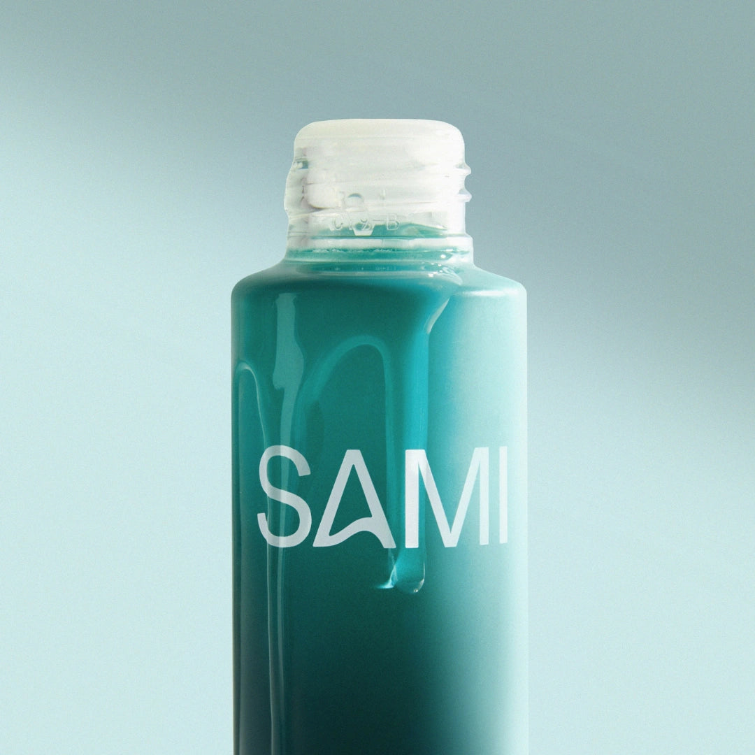 Close-up of SAMI Nourishing Oil Cleanser teal bottle highlighting nourishing oil texture