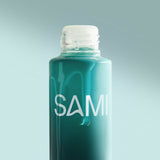 Close-up of SAMI Nourishing Oil Cleanser teal bottle highlighting nourishing oil texture