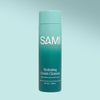 No rinse face cleanser by SAMI Skincare hydrating cream cleanser with hyaluronic acid and gotu kola in sustainable bottle on a green background.