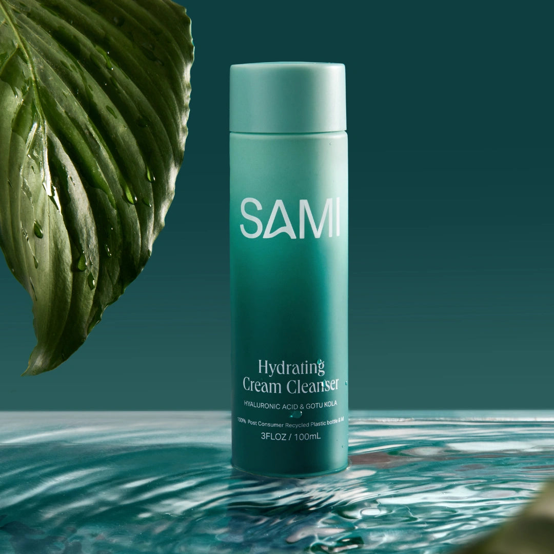 Hydrating cream cleanser by SAMI with hyaluronic acid and gotu kola no rinse face cleanser on water with botanical leaf.