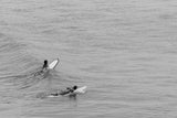 two women surfing in the ocean